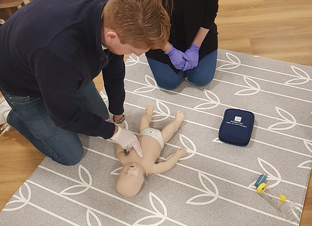 resuscitation training on baby dummy - Beaches First Aid
